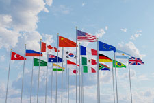 A picture of more than a dozen countries' flags blowing in the wind.