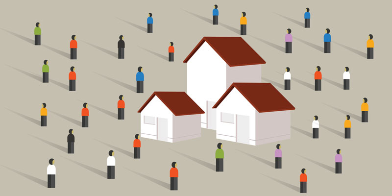 Image of houses with lots of people surrounding them.