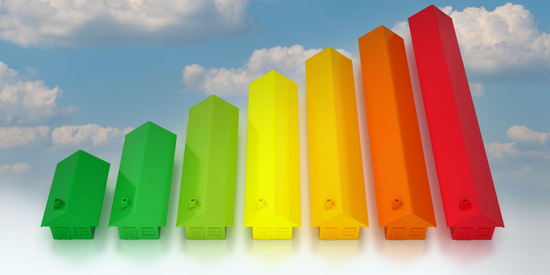 Image of seven houses in different colors and increasingly larger sizes made to look like a column chart on a backdrop of clouds.